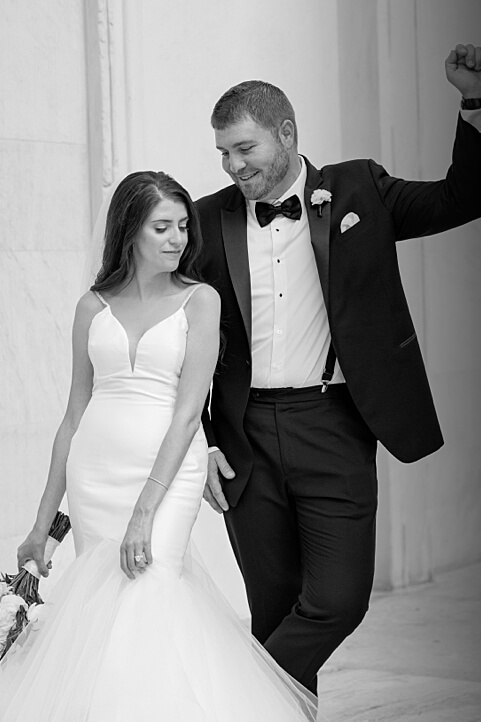 Stylish young couple posing outside of the second bank in Philadelphia on their wedding day